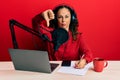 Beautiful middle age woman working at radio studio with angry face, negative sign showing dislike with thumbs down, rejection Royalty Free Stock Photo