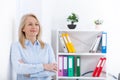 Business woman standing near the wall looking out the window thinking over the strategy. Royalty Free Stock Photo