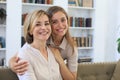 Beautiful middle aged mom and her adult daughter are hugging, looking at camera and smiling Royalty Free Stock Photo