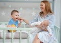 Happy middle aged mother with her children in a bed Royalty Free Stock Photo