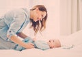 Happy middle aged mother with her child in a bed Royalty Free Stock Photo