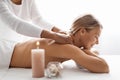 Beautiful middle aged woman having relaxing full body massage at spa salon Royalty Free Stock Photo