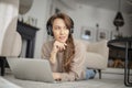 Happy woman wearing headphone and using laptop while relaxing at home Royalty Free Stock Photo