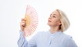 Beautiful middle aged woman with menopause blowing by fan. Hormone replacement therapy and mature woman healthcare. Mid age happy Royalty Free Stock Photo