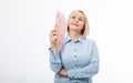 Beautiful middle aged woman with menopause blowing by fan. Hormone replacement therapy and mature woman healthcare. Mid age happy Royalty Free Stock Photo