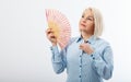 Beautiful middle aged woman with menopause blowing by fan. Hormone replacement therapy and mature woman healthcare. Mid age happy Royalty Free Stock Photo