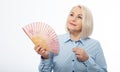 Beautiful middle aged woman with menopause blowing by fan. Hormone replacement therapy and mature woman healthcare. Mid age happy Royalty Free Stock Photo