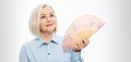 Beautiful middle aged woman with menopause blowing by fan. Hormone replacement therapy and mature woman healthcare. Mid age happy Royalty Free Stock Photo