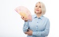 Beautiful middle aged woman with menopause blowing by fan. Hormone replacement therapy and mature woman healthcare. Mid Royalty Free Stock Photo