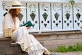 Beautiful middle-aged woman in a straw hat and in a white dress Royalty Free Stock Photo