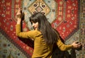 Beautiful middle eastern Girl in Golden Dress Lean to perfect Moroccan Carpet in Marrakech