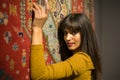 Beautiful middle eastern Girl in Golden Dress Lean to perfect Moroccan Carpet in Marrakech