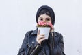 Beautiful middle-eastern girl holding decorative basket full of flowers. Cute Arabian Muslim woman received unique flower bouquet