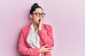 Beautiful middle eastern woman wearing business jacket and glasses bored yawning tired covering mouth with hand