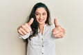 Beautiful middle eastern woman wearing casual clothes approving doing positive gesture with hand, thumbs up smiling and happy for Royalty Free Stock Photo