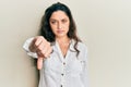 Beautiful middle eastern woman wearing casual clothes looking unhappy and angry showing rejection and negative with thumbs down Royalty Free Stock Photo