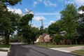 Midwest Neighborhood Street with Old Homes and Green Trees during the Summer in Lemont Illinois