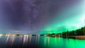 Beautiful Milky Way galaxy close to Aurora, scenic panorama of Northern Lights over calm night Stocksjo lake in Northern Sweden, Royalty Free Stock Photo
