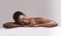 Beautiful millennial afro woman relaxing after beauty treatment or massage Royalty Free Stock Photo
