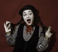 Beautiful mime girl smiles and holds her pigtails with her hands