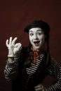 Beautiful mime girl smiling, showing ok sign