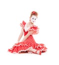 Beautiful mime in red dress sitting on the floor