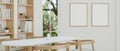 A beautiful and minimal dining table in a Scandinavian minimal white dining room Royalty Free Stock Photo