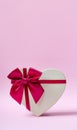 Beautiful minimalist card with a heart shaped gift box on a pink background Royalty Free Stock Photo