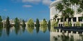 Beautiful mirror reflection of trees and parts of walls stadium in water of fountain `Infinity`. Public landscape park