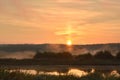 Beautiful misty foggy sunrise in summer.Ponds near forest