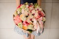 Beautiful mixed flower bouquet hold by woman