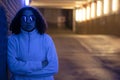 Beautiful mixed race African American girl teenager female young woman wearing sunglasses in a modern underground urban city