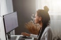 Beautiful mixed-race female coder working on new project texting on computer in apartment Royalty Free Stock Photo
