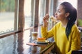 Beautiful mixed race teenage girl in coffee shop Royalty Free Stock Photo