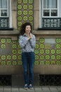 Beautiful mixed-race woman near the wall of the house in Porto Royalty Free Stock Photo