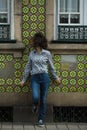 Beautiful mixed-race woman posing near the wall of the house in Porto Royalty Free Stock Photo