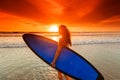 Woman on beach holding surfboard Royalty Free Stock Photo