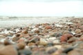 Beautiful mixture of black stones and seashells on sand. View from above