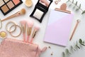 Beautiful mockup flat lay design for blogging workplace background. Cosmetics, makeup brushes, cosmetic bag, palette