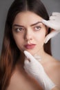 Beautiful model applying cosmetic cream treatment on her face Royalty Free Stock Photo