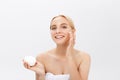 Beautiful model applying cosmetic cream treatment on her face on white Royalty Free Stock Photo