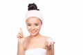 Beautiful model applying cosmetic cream treatment on her face on white Royalty Free Stock Photo