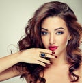 Beautiful model brunette with long curled hair. Royalty Free Stock Photo