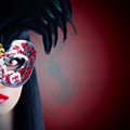 Beautiful model in carnival mask with red lips