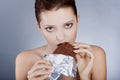 Beautiful model eating chocolate, in the studio Royalty Free Stock Photo