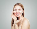 Beautiful model girl applying cosmetic cream treatment on her face on white. Healthy woman portrait Royalty Free Stock Photo