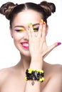 Beautiful model girl with bright colored makeup and nail polish in the summer image. Beauty face. Short colored nails.