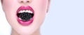 Beautiful model girl eating blackberry, closeup. Beauty young fashion woman lips with fresh organic black berry