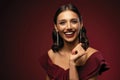 Beautiful model girl with elegant hairstyle in red dress. Woman with red lips and nails. Royalty Free Stock Photo