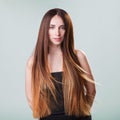 Beautiful model girl with shiny flying brown ombre straight long hair . Care and hair products . Royalty Free Stock Photo